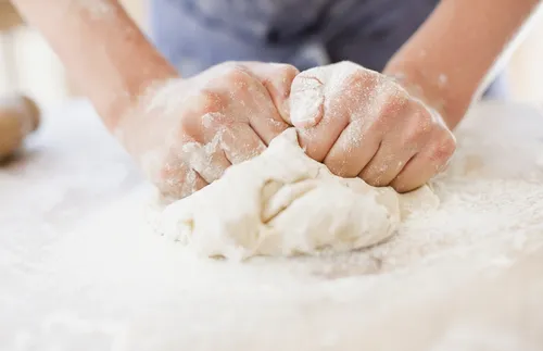 hands kneading dough
