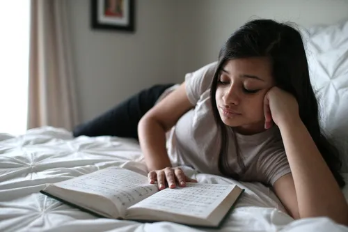 young woman reading book