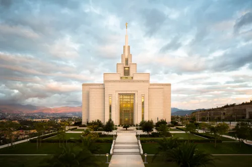 A view of the Tegucigalpa Honduras Temple in the evening, including the stairs, grounds, trees, and bushes.
