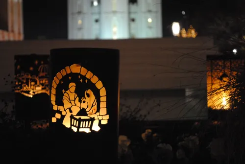 A view of several luminarias on Temple Square at Christmastime, the one in the front depicting the Nativity scene.