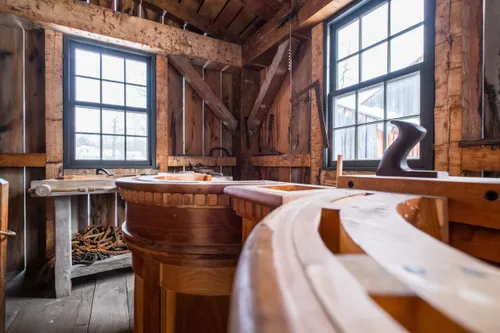 Interior of a wooden building with carpentry tools.