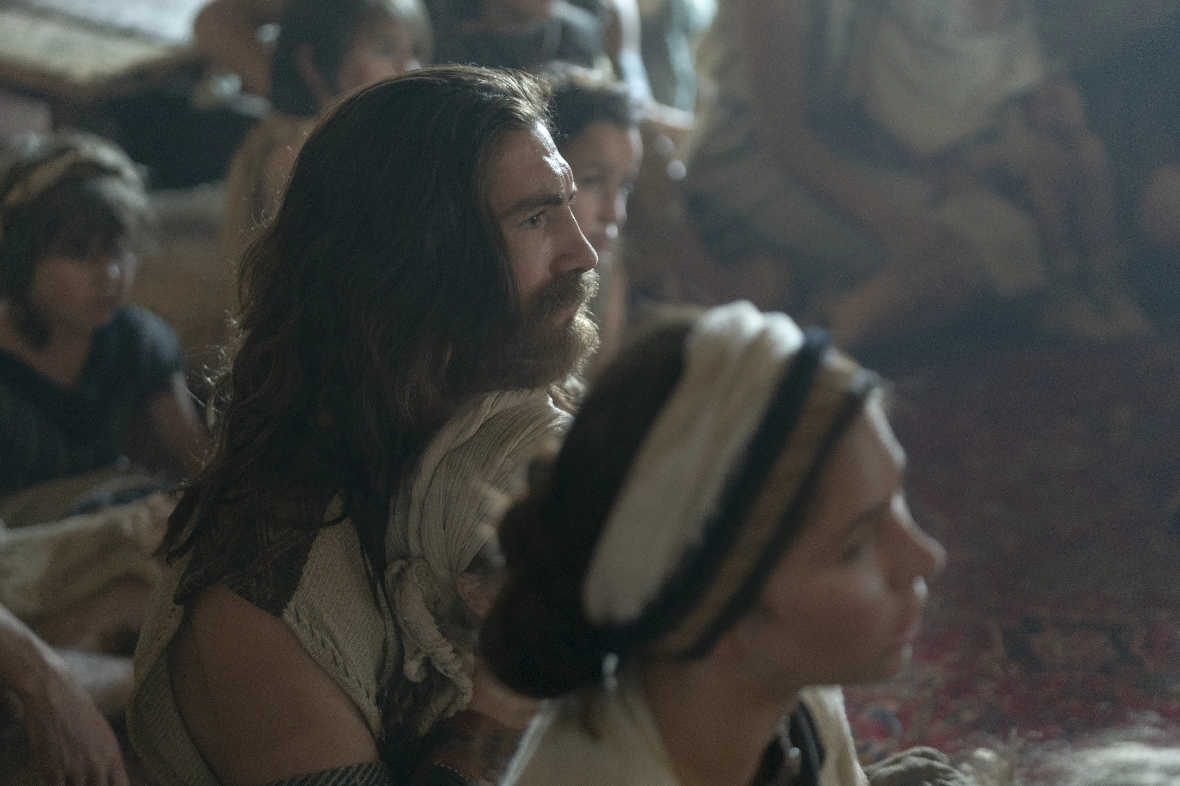 Nephi and his wife listen as Lehi teaches his family.