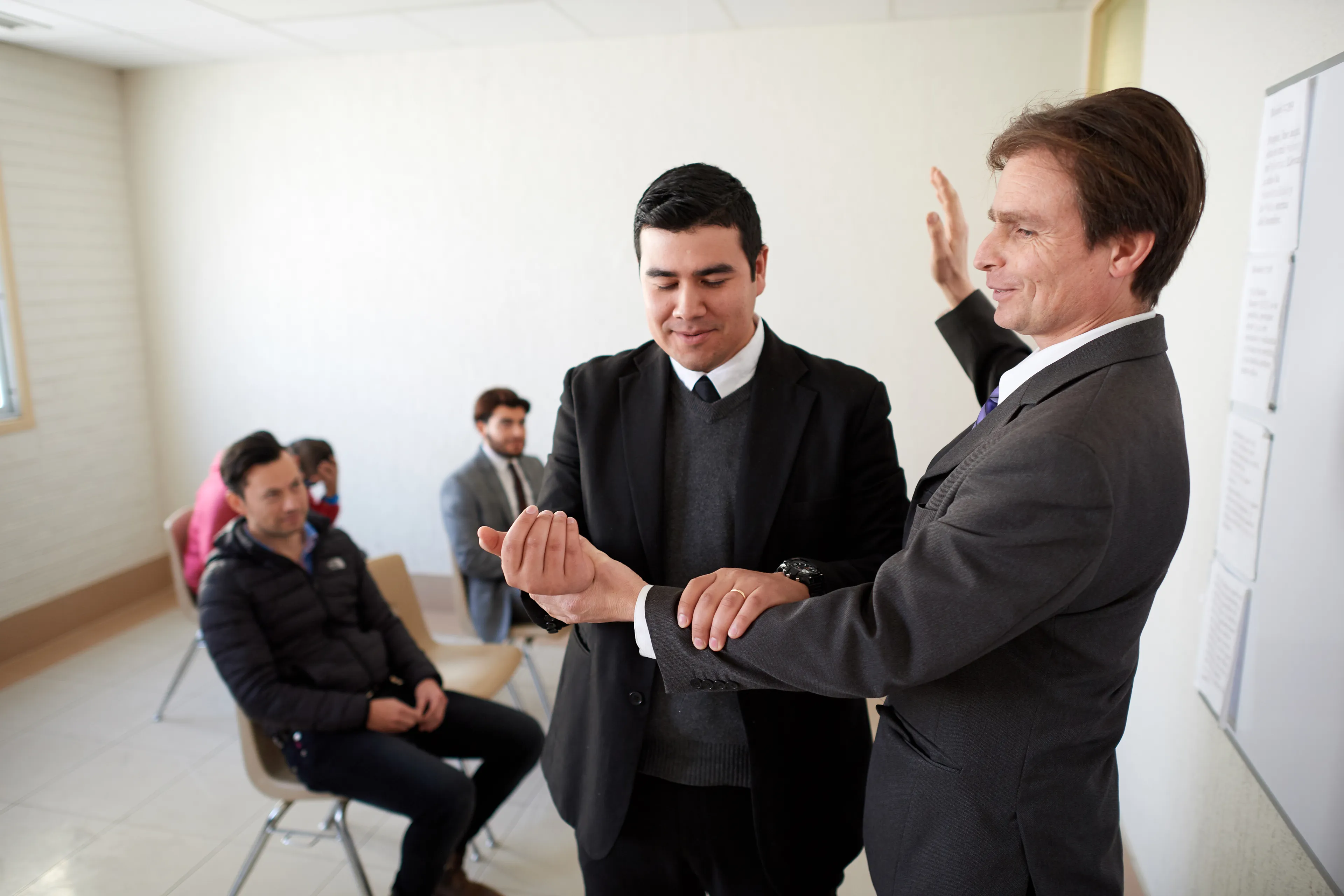 An elders quorum going over the steps for performing baptisms.