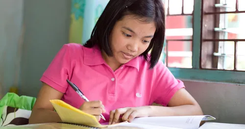 young woman writing in notebook