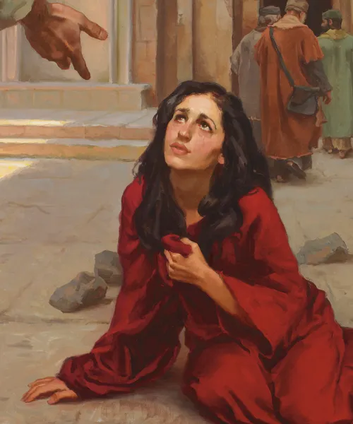 a woman looking up at Jesus’s outstretched hand