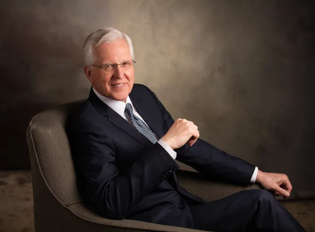 Portrait of Elder D. Todd Christofferson.  He is sitting in a chair with one hand partially raised, the other hand on the arm of the chair.  Photographed in March 2020.