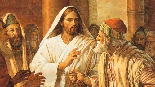Jesus Christ clasping a man’s withered hand as He heals him