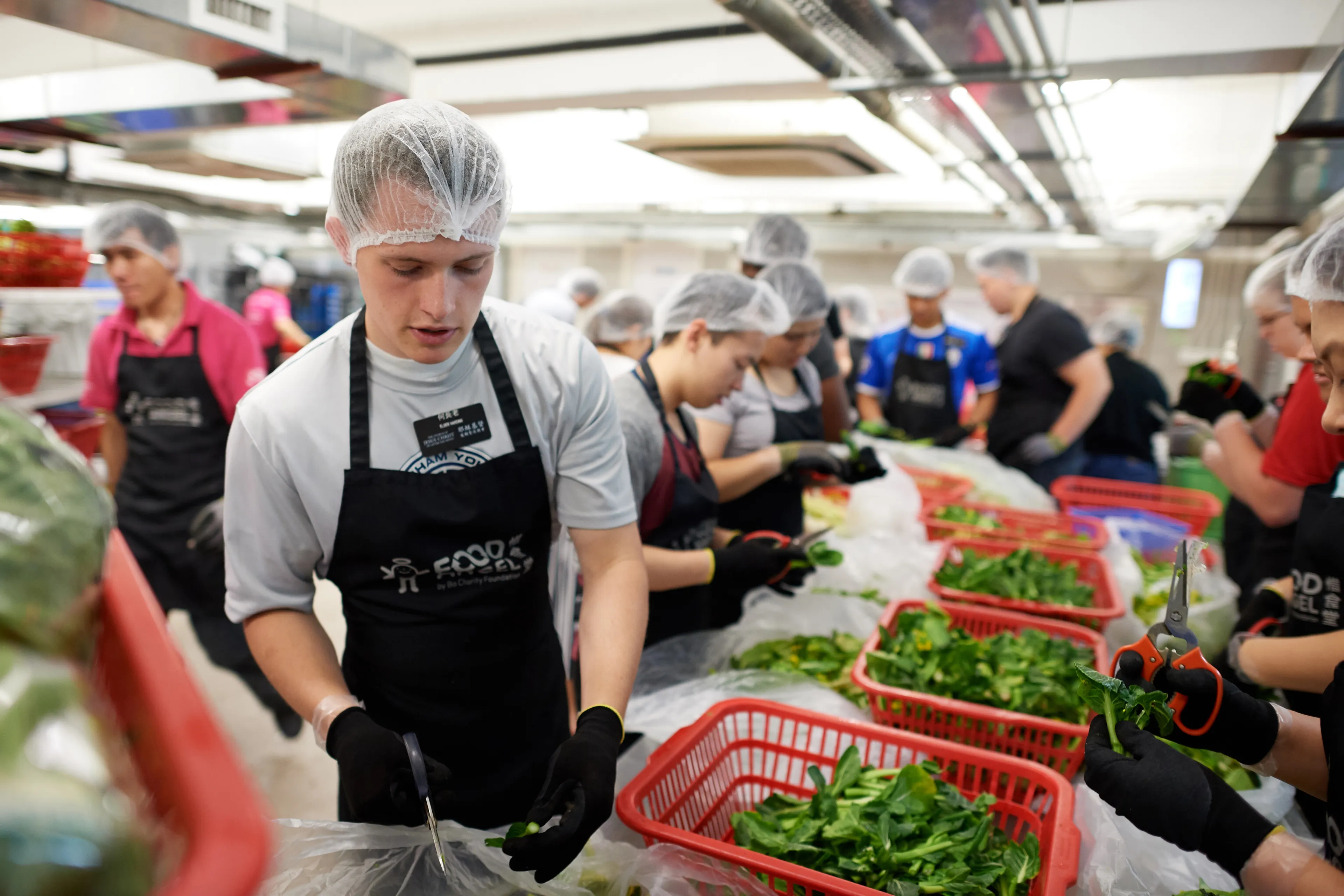 Missionaries helping distribute food during a service project in Hong Kong.