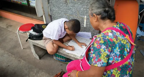 grandmother helping child study