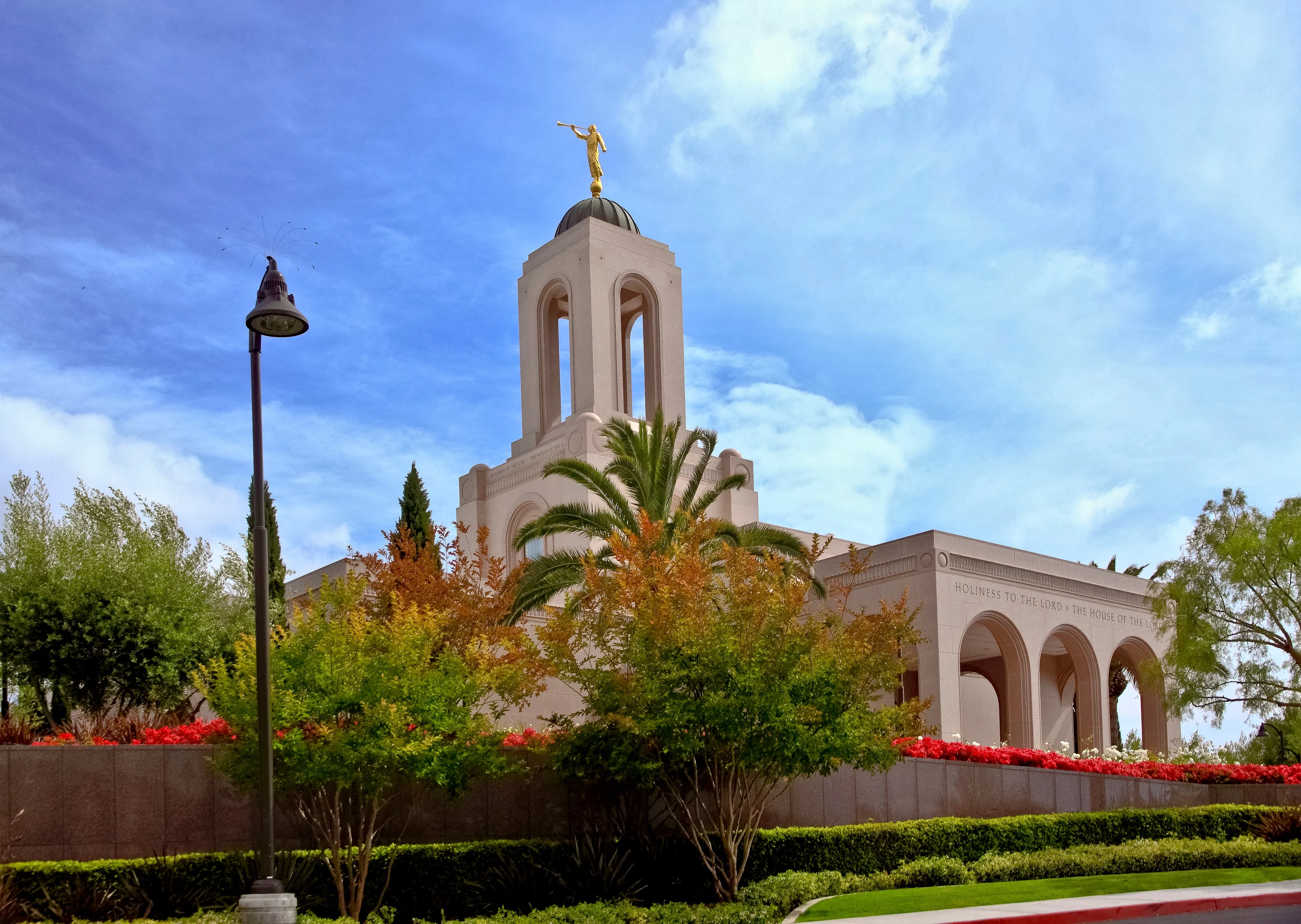The Newport Beach California Temple, including the spire, entrance, and scenery.