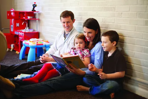 Family reading a book.