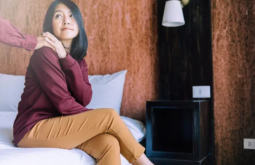 woman sitting on bed