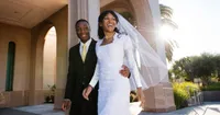 A newly married bride and groom walking outside the Newport Beach California Temple. Why Temple Marriage?
