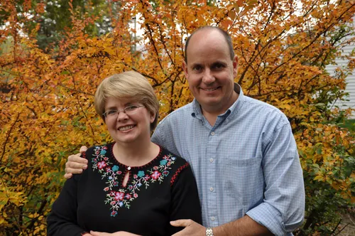 A couple standing in an outdoor setting.