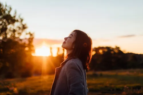 woman outdoors enjoying beautiful evening