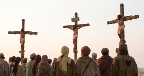 Jesus is on the cross between two malefactors, there is a crowd below that are watching. Outtakes include a sponge on a stick lifted up to Jesus by a Roman soldier, different views of the three me on the crosses, soldiers gambling and parting his clothes, Jesus walking wearing crown of thorns and covered in blood, and Caiaphas.