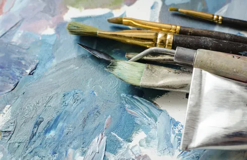 paintbrushes and oil paint tubes