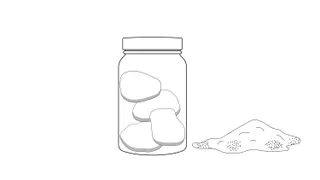 Jar full of rocks with sand or dirt on the side