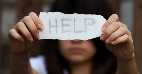 handwritten note saying “HELP”