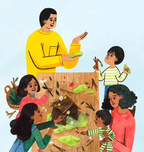A family sitting at a table making a Nativity set from nature objects
