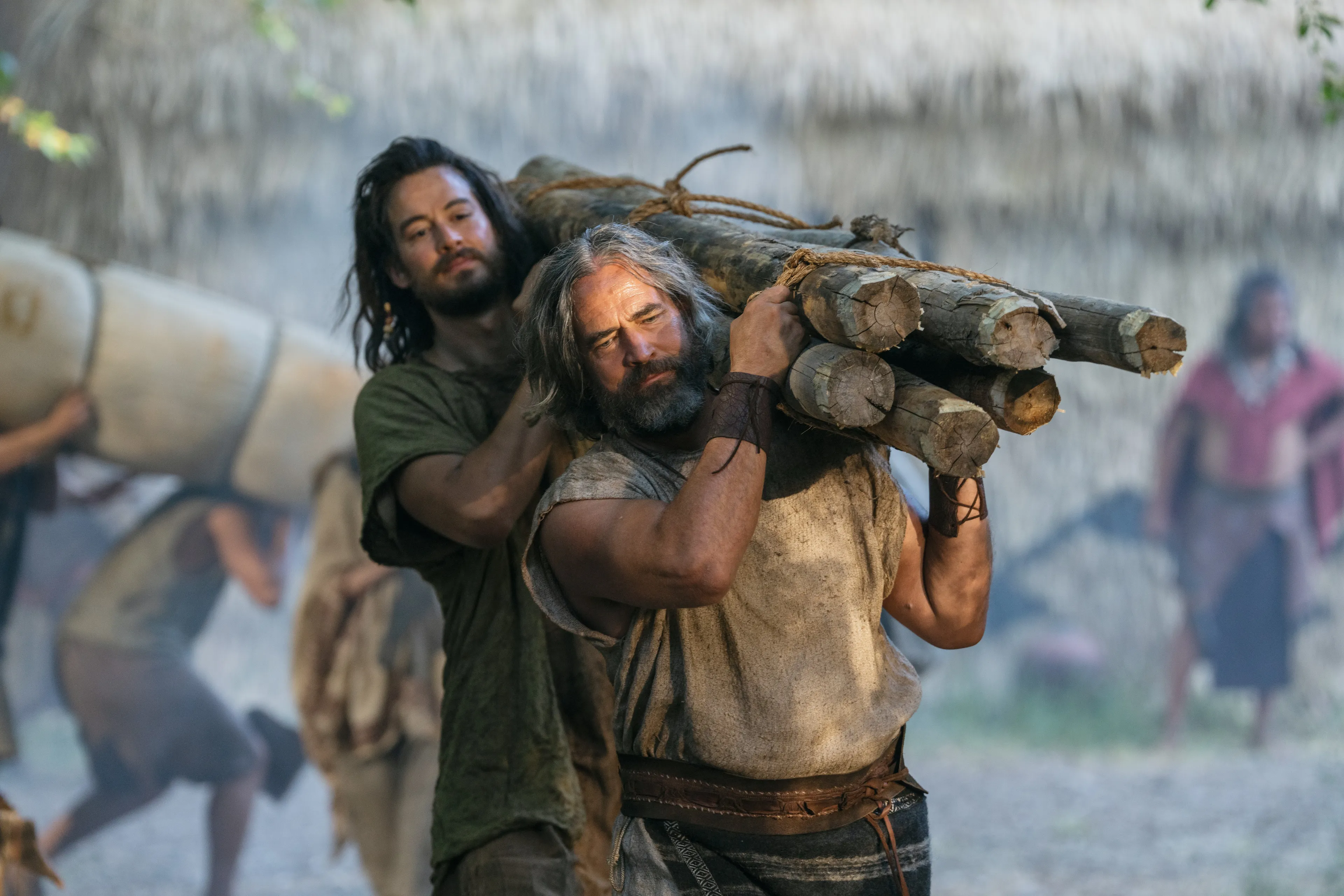 Alma and Helem carry a bundle of logs during their bondage to the Lamanites.