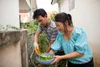 man and woman harevesting from a garden