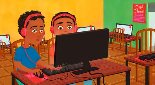 two boys in internet cafe looking at computer