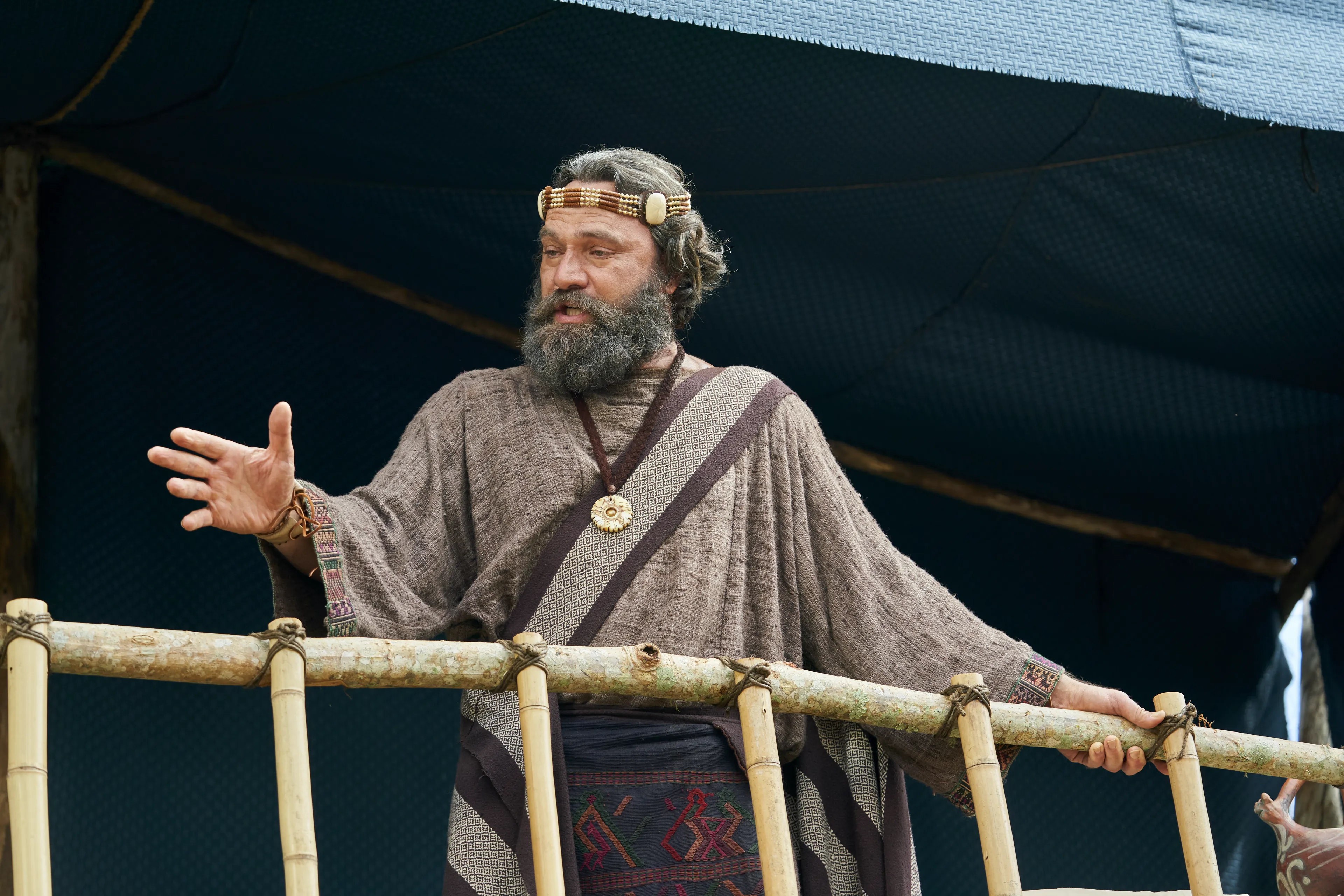 King Benjamin stands on a tower speaking to the Nephites in the Land of Zarahemla.