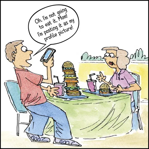 young man taking a picture of his sandwich