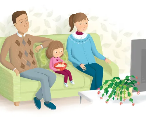 Girl and her parents sitting on a sofa watching the television