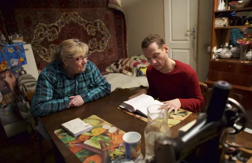 Victor sitting by his grandmother