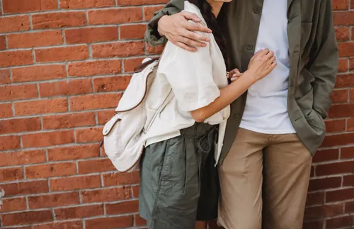 man with his arm around a woman