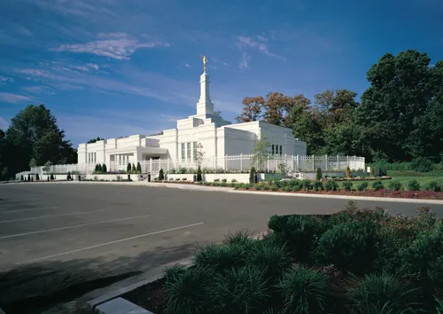 A view of the Louisville Kentucky Temple from across the parking lot, behind a white fence.