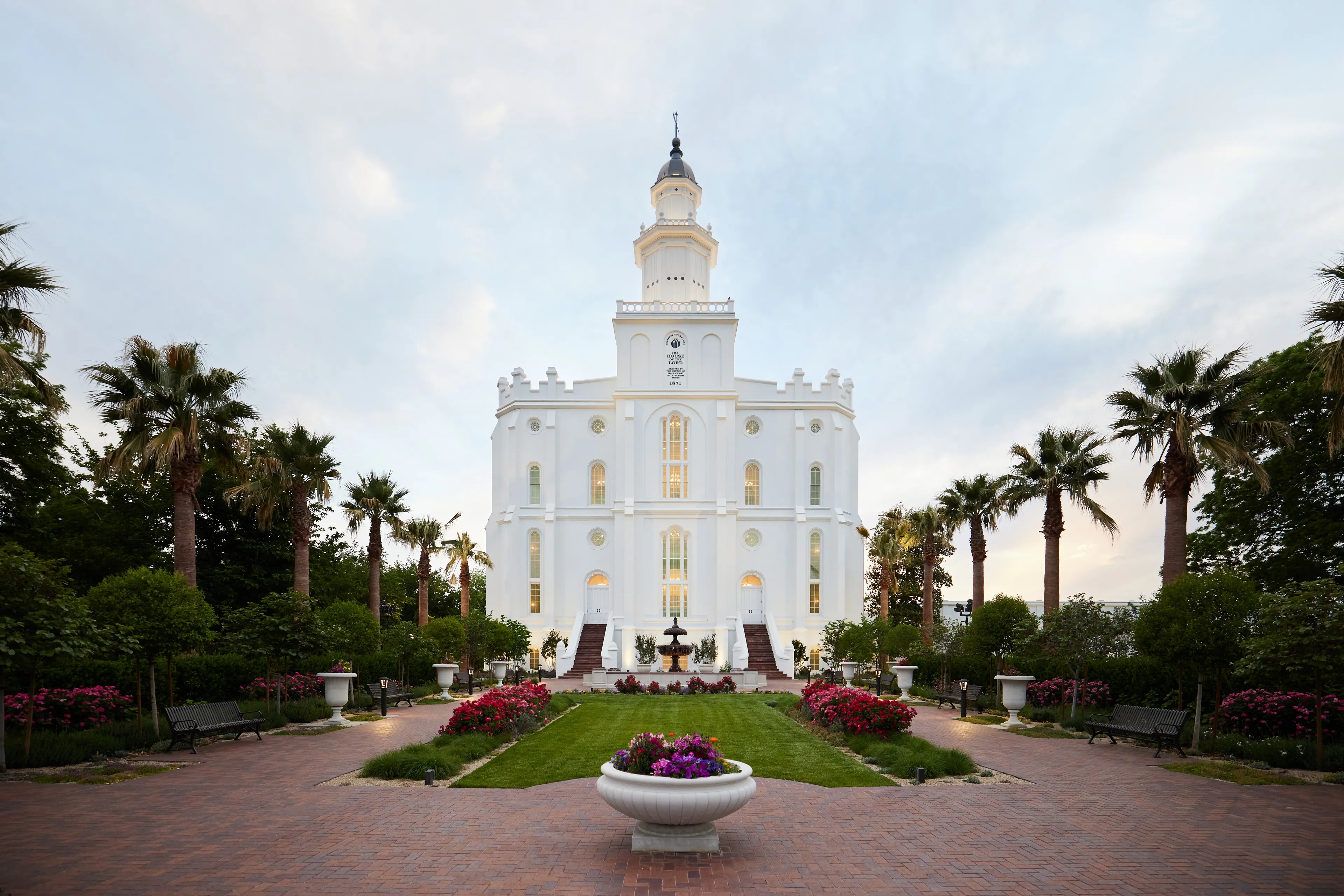 Exterior image of the St. George Utah Temple. The image features the temple set around trees surrounding the temple grounds. 