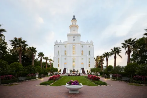 Exterior image of the St. George Utah Temple. The image features the temple set around trees surrounding the temple grounds. 