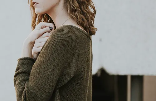 Young adult woman with hands over heart