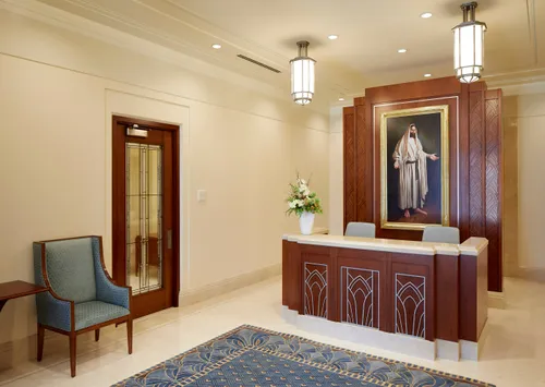 check-in desk with painting of Jesus on wall