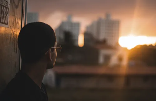 Man looking toward sunlight