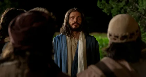 Jesus has his eyes closed in prayer