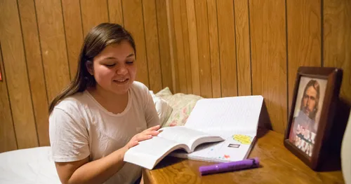 young woman reads her scriptures