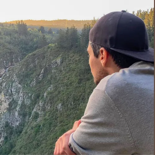 the author looking out over a waterfall