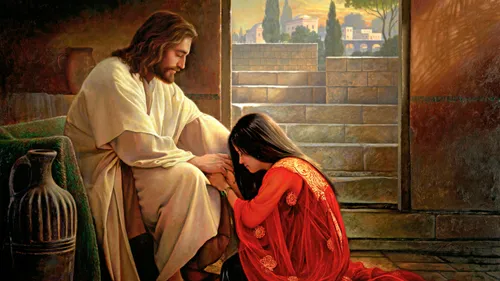 woman kneeling down at Jesus’s feet
