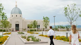 Young man strides toward the Tucson Arizona Temple, his sister follows