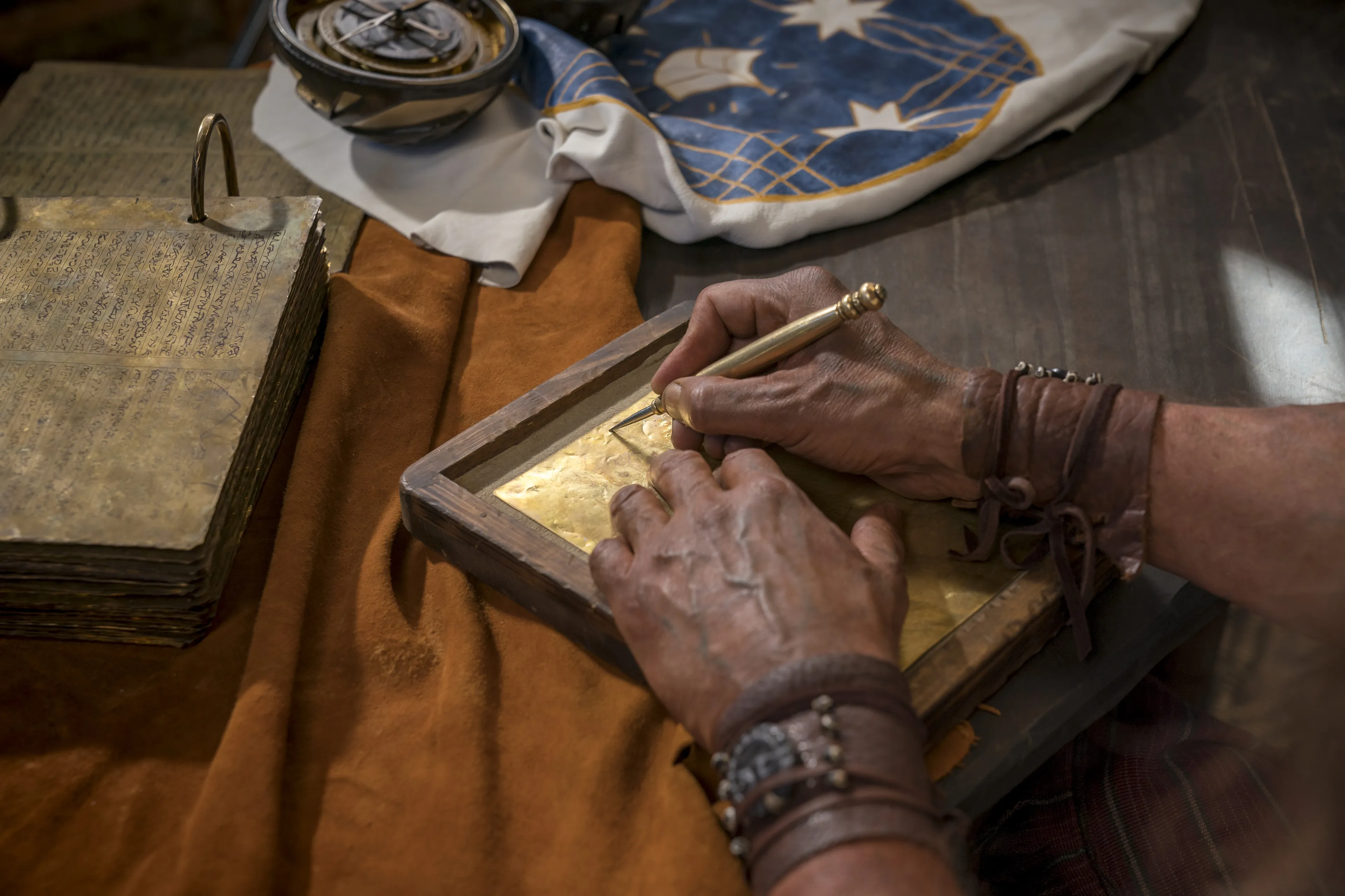 Nephi engraves on metal plates.