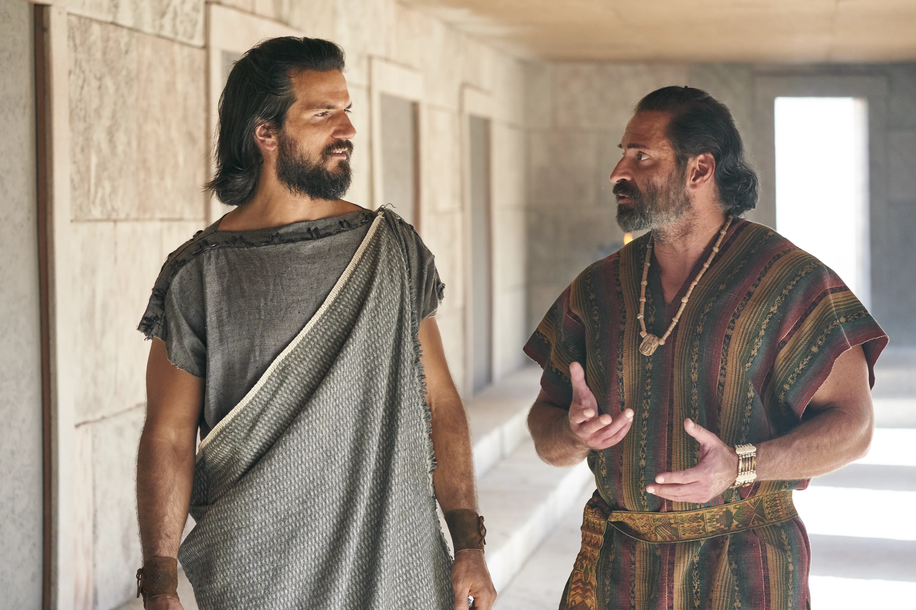 Alma the Younger listens as Amulek speaks to him in the city of Ammonihah.