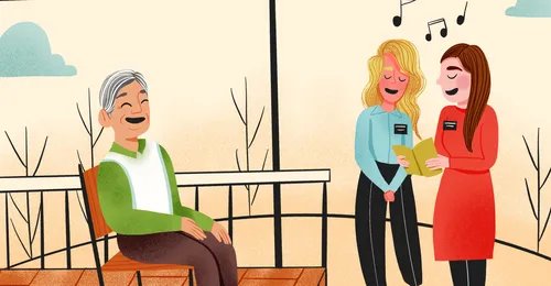 sister missionaries singing with older man