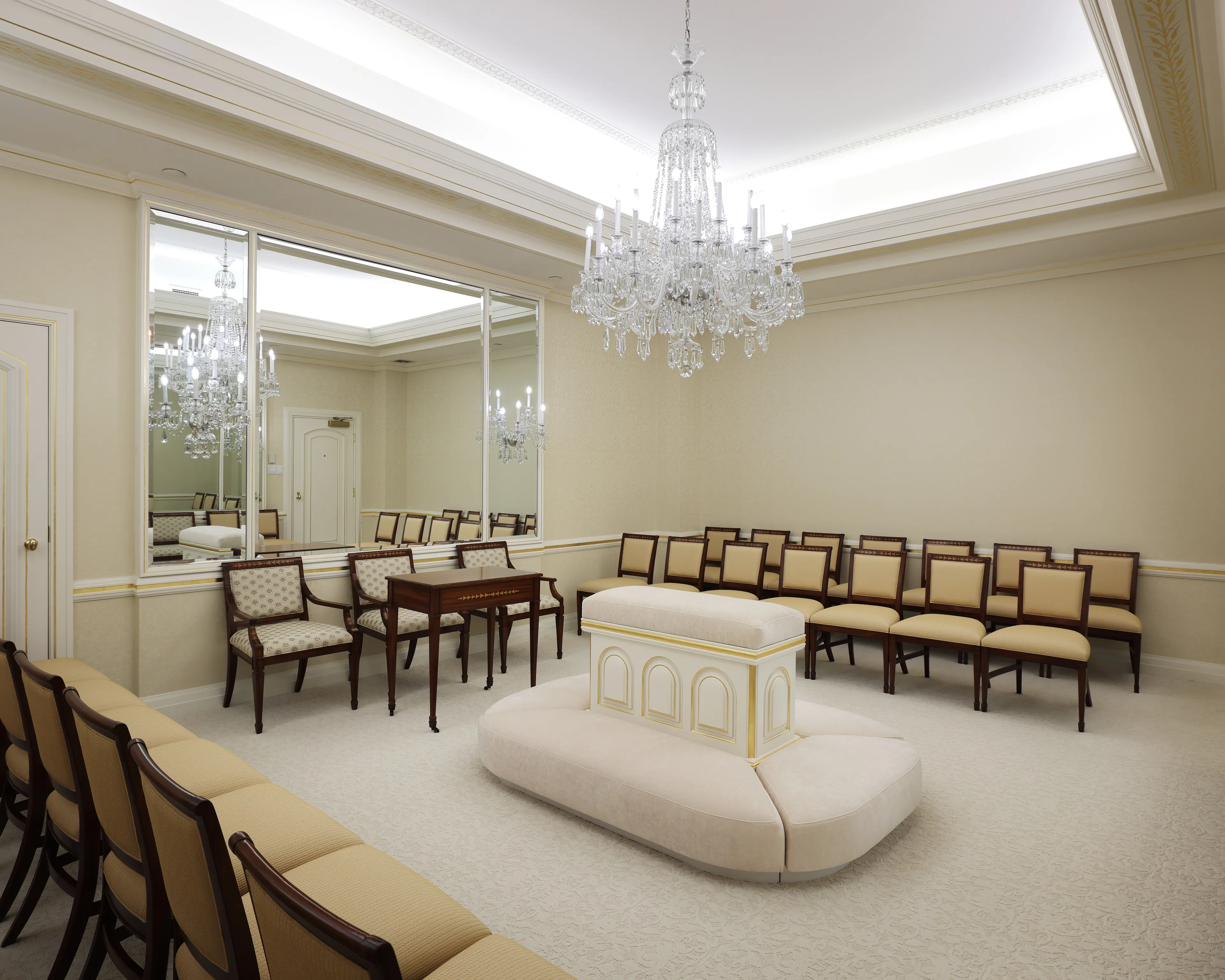 Interior image of the Toronto Ontario Temple featuring architectural details throughout the room. We see a chandelier suspended above the altar. © undefined ipCode 1.