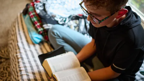 a young man reading the scriptures