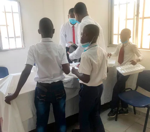 Animan helping prepare the sacrament