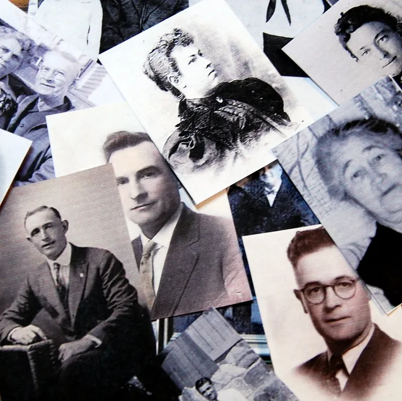 Old family pictures laying on a kitchen table pointing to the importance of family